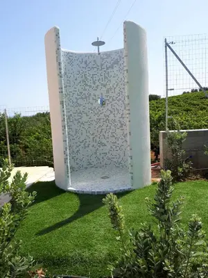 a large white surfboard sitting on the grass at Spacious villa with sea and mountain views in Alcamo in Alcamo