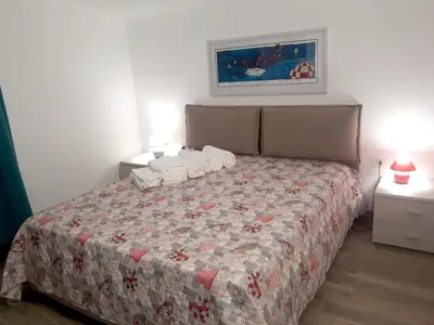 a bedroom with a bed with a quilt on it at Spacious villa with sea and mountain views in Alcamo in Alcamo