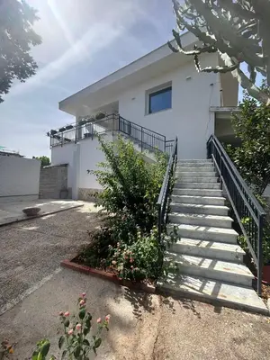 a white house with stairs in front of it at Mondello Felix - appartamenti in villa a 600m dal mare in Mondello