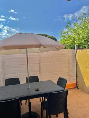 a table with an umbrella on a patio at Xenia House in Lascari