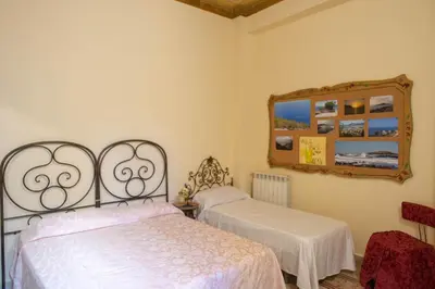 a bedroom with two beds and a mirror at ERCTA in Palermo