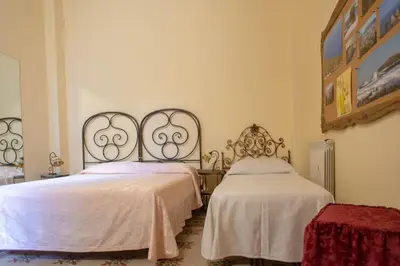 a bedroom with two beds with white sheets at ERCTA in Palermo