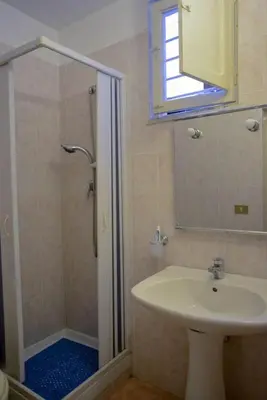a bathroom with a shower and a sink and a mirror at ERCTA in Palermo