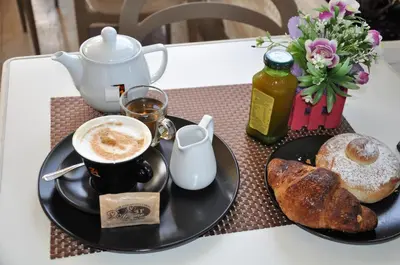 a table with a cup of coffee and a plate of bread at Casa Rosetta in Palermo