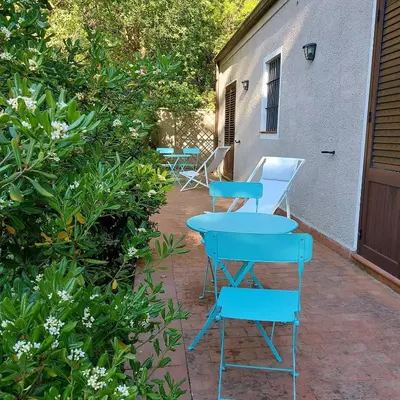 four blue tables and chairs sitting on a patio at Chiosi Country Club in Corleone
