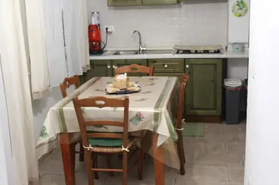a kitchen with a table with a cake on it at casa salusa in Terrasini