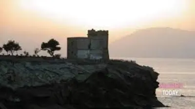 a building on top of a cliff near the ocean at casa salusa in Terrasini