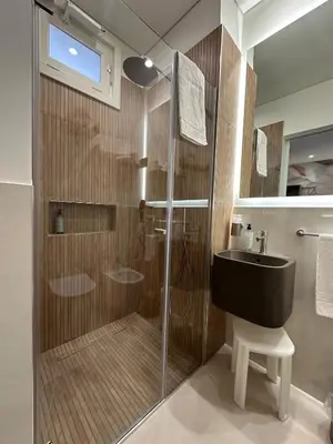 a bathroom with a glass shower and a sink at Agave Superior Rooms in San Vito lo Capo