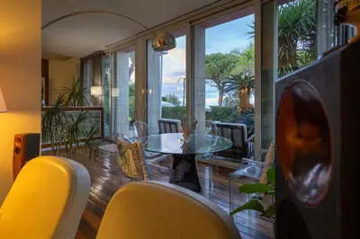 a living room with a glass table with vases on it at Villa Olimpia in Mondello
