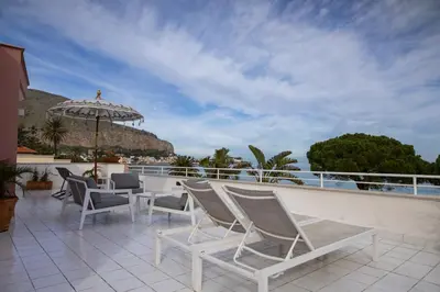 a bedroom with a bed and a living room at Villa Olimpia in Mondello