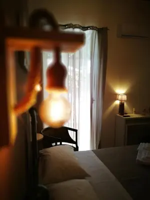 a bedroom with a bed with a lamp and a window at BELLA PALERMO in Palermo