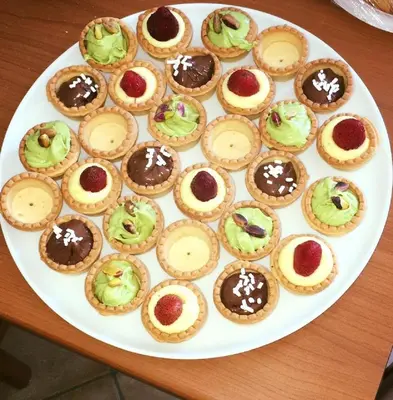 a plate of cupcakes on top of a table at Hotel Baia Di Venere in San Vito lo Capo