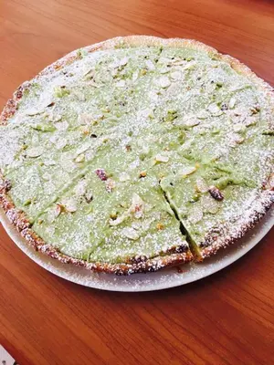 a pizza sitting on top of a table at Hotel Baia Di Venere in San Vito lo Capo