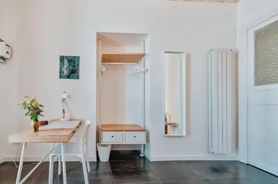 a dining room with a table and a desk at casaDamare in Palermo