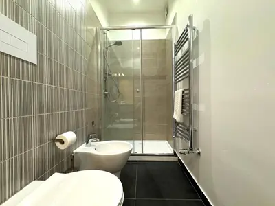 a bathroom with a shower and a toilet and a sink at Casa di Mami in Capaci