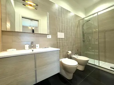 a bathroom with a toilet and a sink and a shower at Casa di Mami in Capaci