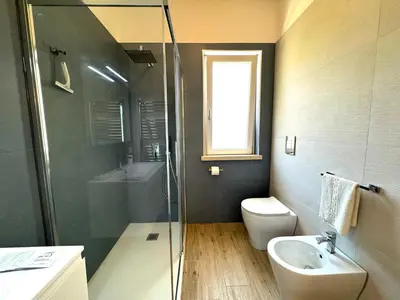 a bathroom with a toilet and a sink and a shower at Casa di Mami in Capaci