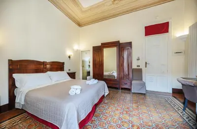 a bedroom with a bed with two towels on it at B&B Novecento in Palermo