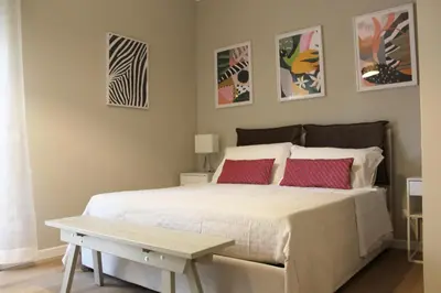 a bedroom with a bed with two red pillows at REALE ORLEANS in Palermo