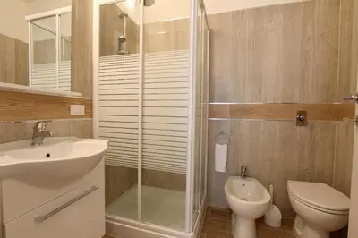 a bathroom with a shower and a sink and a toilet at B&B Siciliò in Santa Flavia