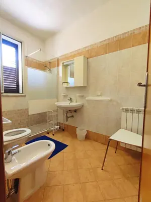 a bathroom with a sink and two toilets at B&B Siciliò in Santa Flavia