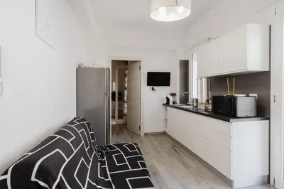 a kitchen with white cabinets and a refrigerator at Costa del Golfo in Castellammare del Golfo