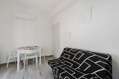 a living room with a table and a couch at Costa del Golfo in Castellammare del Golfo