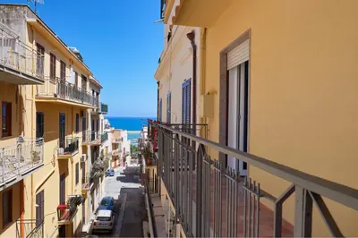 a view of a city street from a balcony at Costa del Golfo in Castellammare del Golfo
