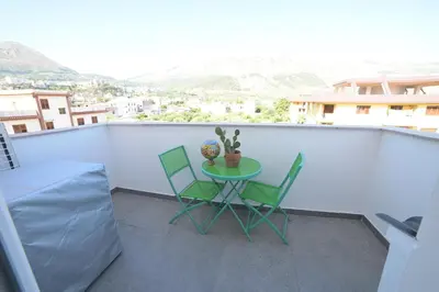 a table and chairs on a balcony with a view at STANZINA DELLA BARONESSA in Carini