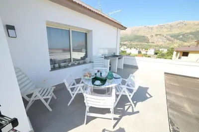 a patio with a table and chairs on a balcony at STANZINA DELLA BARONESSA in Carini