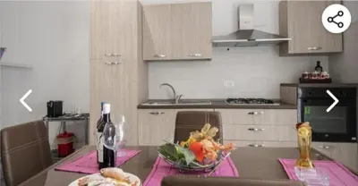 a kitchen with a table with a bowl of food on it at Appartamento solare in Castellammare del Golfo