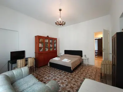 a living room with a bed and a couch at Genio del Porto - Mabbonath in Palermo