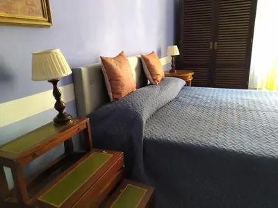 a bedroom with a bed and a table with a lamp at Genio del Porto - Mabbonath in Palermo