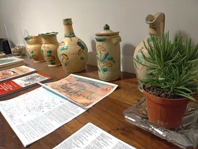 a table with vases and a potted plant on it at Genio del Porto - Mabbonath in Palermo