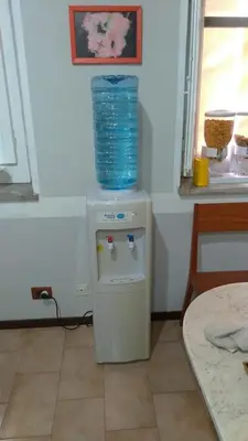 a small refrigerator with a blue bucket on top of it at Genio del Porto - Mabbonath in Palermo