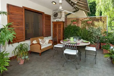 a patio with a table and chairs and plants at casa Morgana in Palermo