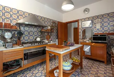 a kitchen with a stove and a sink in a room at casa Morgana in Palermo