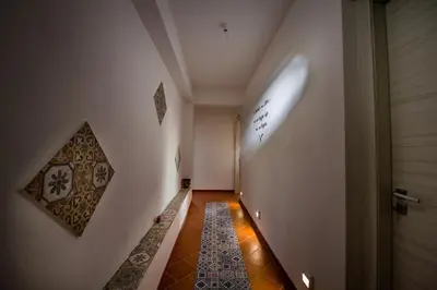 a hallway with a door and a tile floor at Piccolo Sole d'oro - appartamenti in Calatafimi