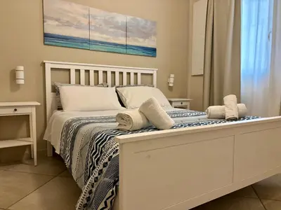a bedroom with a white bed with towels on it at Palermo Centre - Apartments with Private Balcony or Terrace in Palermo