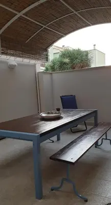 a picnic table and a bench in a room at Casa Vacanze L'isola del Relax in Isola delle Femmine
