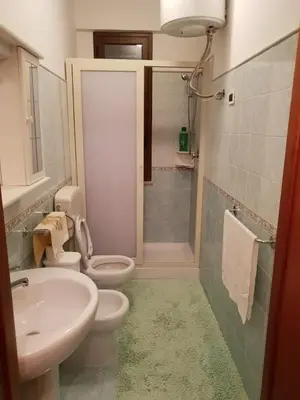 a bathroom with a sink and a toilet and a shower at Appartamento 60 mq a 800 mt dalla spiaggia in Capaci