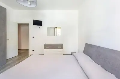 a bedroom with a bed and a tv on a wall at E.R. Apartment in Palermo