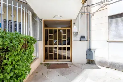 an entrance to a building with a wooden door at E.R. Apartment in Palermo