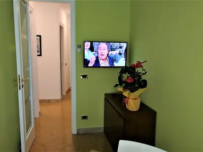 a bedroom with a large bed with a red bedspread at Elerà holiday apartment in Palermo