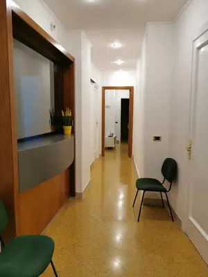 a bedroom with a red bed and a couch at Elerà holiday apartment in Palermo