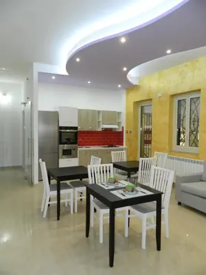 a kitchen and dining room with tables and chairs at LE STANZE DI LUCA in Palermo