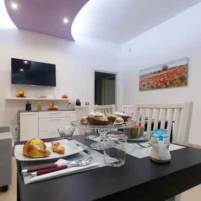 a kitchen with a table with plates of food on it at LE STANZE DI LUCA in Palermo