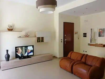a living room with a couch and a flat screen tv at Casa Lidia in Castellammare del Golfo