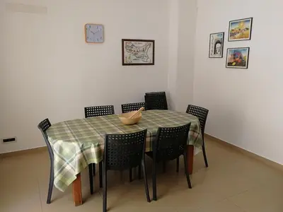 a dining room table with chairs with a platter on it at Casa Lidia in Castellammare del Golfo