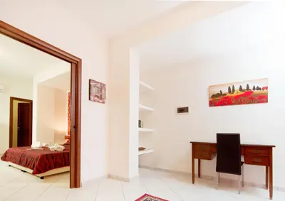 a bedroom with a desk and a mirror at Sosta dei Garibaldini in Campofelice di Roccella